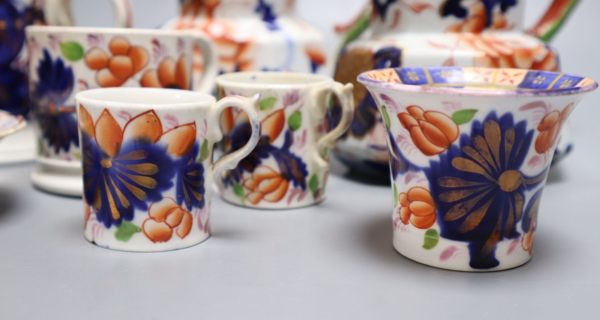 Eight pieces of Ironstone china including two jugs and a three handled cider mug